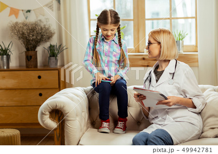 A girl playing games on a phone at hospital. A girl playing games on a phone at hospital. 49942781
