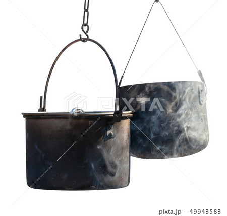 Two sooty old cauldrons in fume isolated on white 49943583