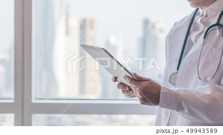 Physician with tablet for patient health record Physician with tablet for patient health record 49943589