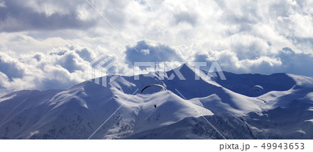 Panoramic view on skydiver at evening cloudy Panoramic view on skydiver at evening cloudy 49943653