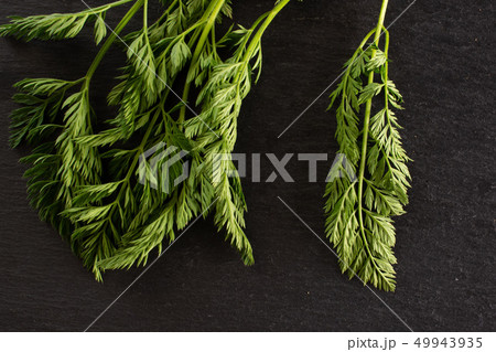 Fresh orange carrot on grey stone Fresh orange carrot on grey stone 49943935