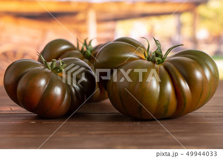 Fresh dark tomato primora with cart 49944033