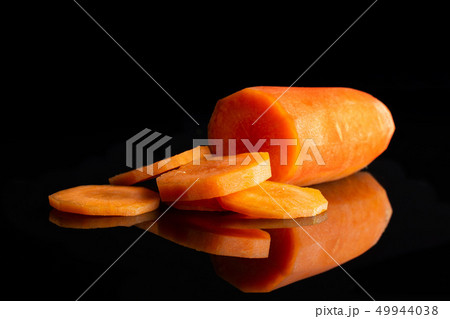 Fresh orange carrot isolated on black glass Fresh orange carrot isolated on black glass 49944038