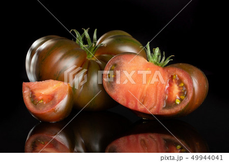 Fresh dark tomato primora isolated on black glass 49944041