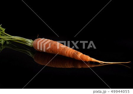 Fresh orange carrot isolated on black glass 49944055