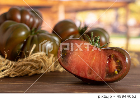 Fresh dark tomato primora with cart Fresh dark tomato primora with cart 49944062