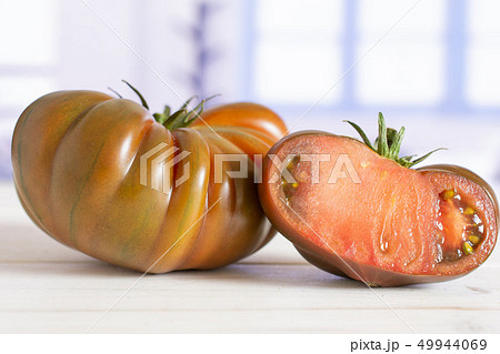 Fresh dark tomato primora with blue window Fresh dark tomato primora with blue window 49944069