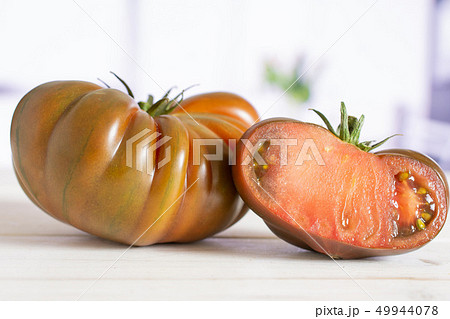 Fresh dark tomato primora with red tulips Fresh dark tomato primora with red tulips 49944078