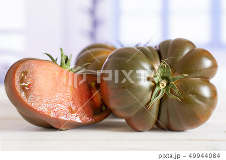 Fresh dark tomato primora with blue window Fresh dark tomato primora with blue window 49944084