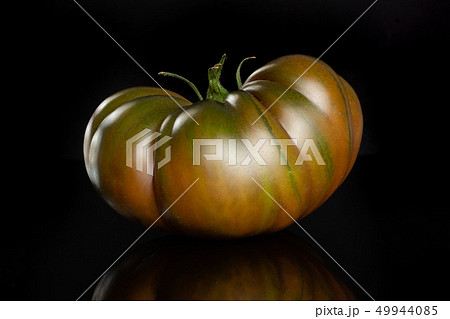 Fresh dark tomato primora isolated on black glass 49944085