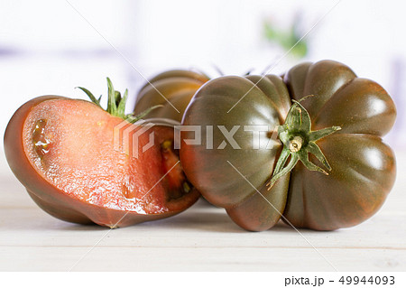 Fresh dark tomato primora with red tulips 49944093