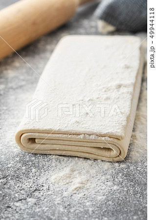 Fresh raw dough on table. Puff pastry. Copy space. 49944118