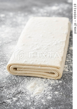 Fresh raw dough on table. Puff pastry. Copy space. 49944119