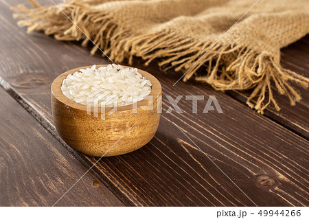 White jasmine rice on brown wood White jasmine rice on brown wood 49944266