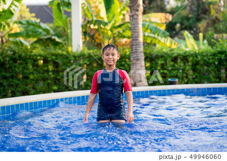 Happy asian kid boy swiming on swiming pool in the Happy asian kid boy swiming on swiming pool in the 49946060