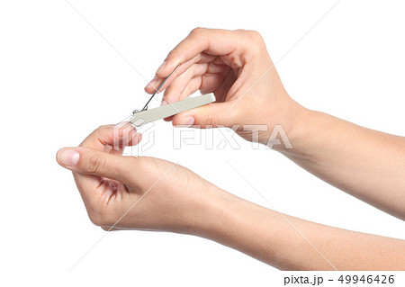 Woman hands using a nail clippers to cut her Woman hands using a nail clippers to cut her 49946426