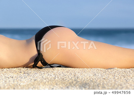 Profile of a butt of a woman with a bikini 49947656