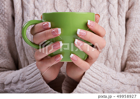 Woman hands with elegant french manicure. Woman hands with elegant french manicure. 49958927