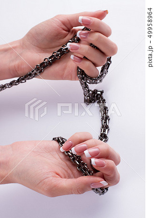 Beautiful female hands hold the chain. Beautiful female hands hold the chain. 49958964