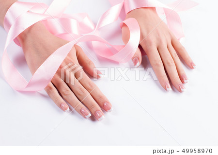 Manicure with delicate pink ribbon. Manicure with delicate pink ribbon. 49958970