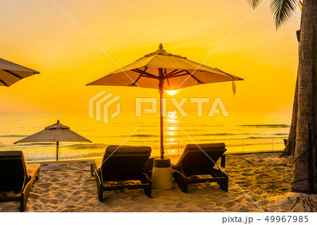 Umbrella and chair on the beautiful beach and sea at sunrise time for travel and vacation Umbrella and chair on the beautiful beach and sea at sunrise time for travel and vacation 49967985