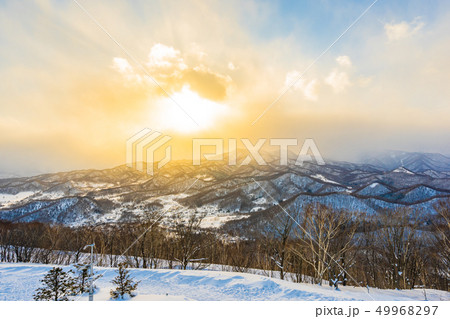 Beautiful landscape with mountain around tree in snow winter season at sunset time Beautiful landscape with mountain around tree in snow winter season at sunset time 49968297
