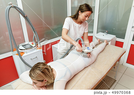 Beautician applying lpg procedure. Anti cellulite 49970368