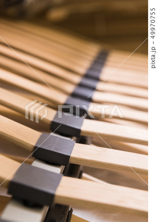 Close-up wooden elements of an arthopedic base of a double bed. Interior structure of furniture Close-up wooden elements of an arthopedic base of a double bed. Interior structure of furniture 49970755