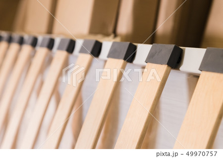 Close-up wooden elements of an arthopedic base of a double bed. Interior structure of furniture Close-up wooden elements of an arthopedic base of a double bed. Interior structure of furniture 49970757