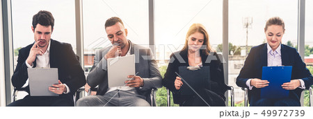 Businesswomen and businessmen wait for interview. 49972739