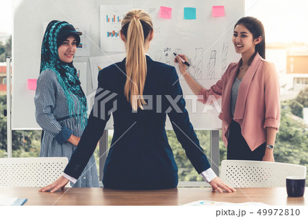 Multicultural working group in teamwork meeting. Multicultural working group in teamwork meeting. 49972810