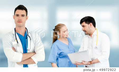 Doctor working in hospital with other doctors. 49972922