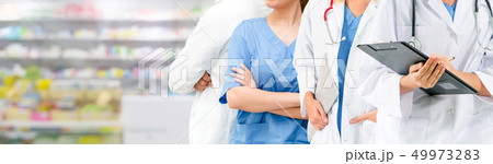 Doctor working in hospital with other doctors. 49973283