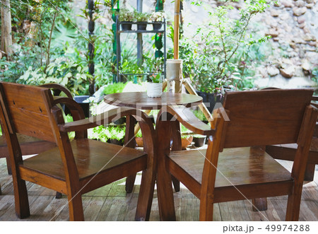 wood chair table on terrace balcony with garden view wood chair table on terrace balcony with garden view 49974288