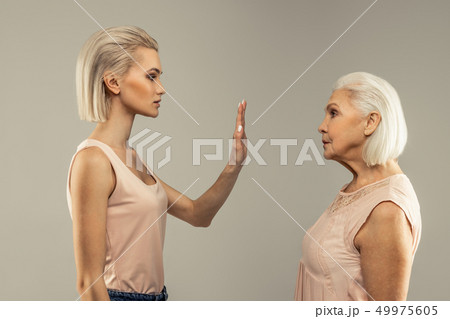 Nice young woman holding hand in front of her 49975605