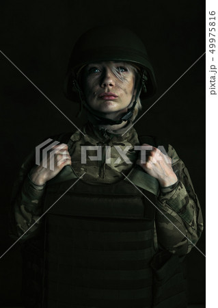 Portrait of young female soldier 49975816