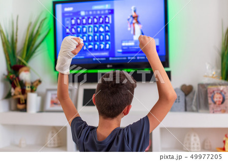 : boy with plaster on his hand rejoices victory in