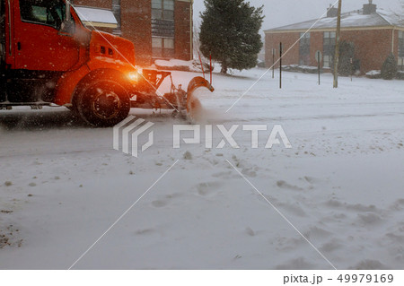 snowplow tractor cleaning a road in winter time 49979169