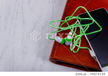Headphones, mobile phone and books on audio book 49979194