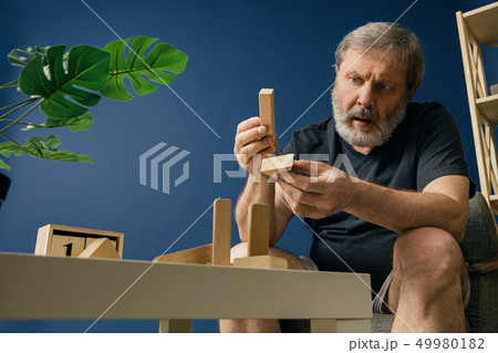 Old bearded man with alzheimer desease 49980182
