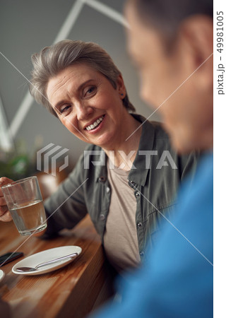 Happy smiling aged woman looking to her friend Happy smiling aged woman looking to her friend 49981005