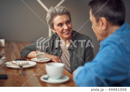 Happy smiling aged couple sitting in cafe Happy smiling aged couple sitting in cafe 49981006