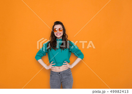 Waist up of attractive fashionable Caucasian girl wearing stylish eyeglasses in studio 49982413