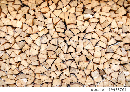 Background of chopped, sawn and stabbed stacked wooden logs. Background of chopped, sawn and stabbed stacked wooden logs. 49983761