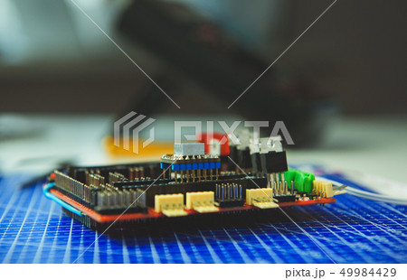 Side view of microcircuit lying on blue board Side view of microcircuit lying on blue board 49984429