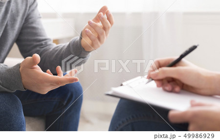 Psychotherapist writing notes, assessing patient's health and giving diagnosis 49986929