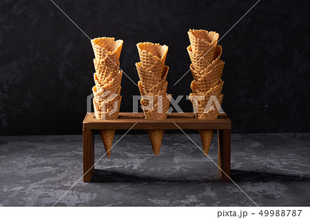Waffle cones in ice cream cone stand on a on black 49988787