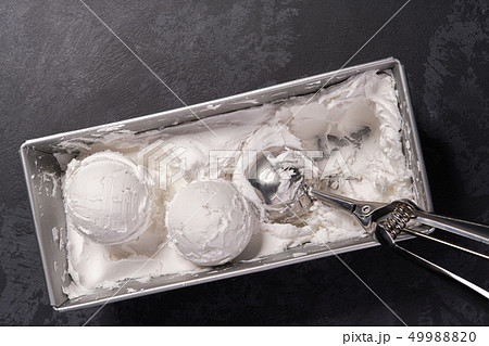 Vanilla ice cream scooped out of container, top Vanilla ice cream scooped out of container, top 49988820