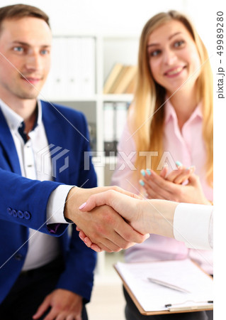 Man in suit shake hand as hello in office closeup 49989280