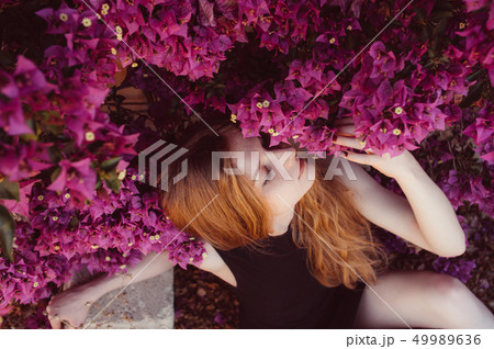 Portrait of girl with closed eyesamong purple Portrait of girl with closed eyesamong purple 49989636